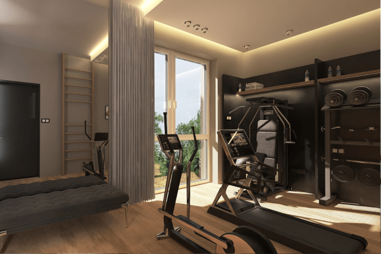 Wnętrze siłowni z nowoczesnym sprzętem fitness i drewnianą podłogą.