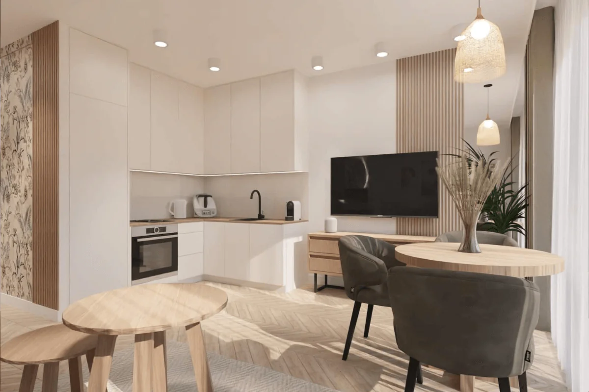 kawalerka wykończona w nowoczesny sposób z jasnymi meblami