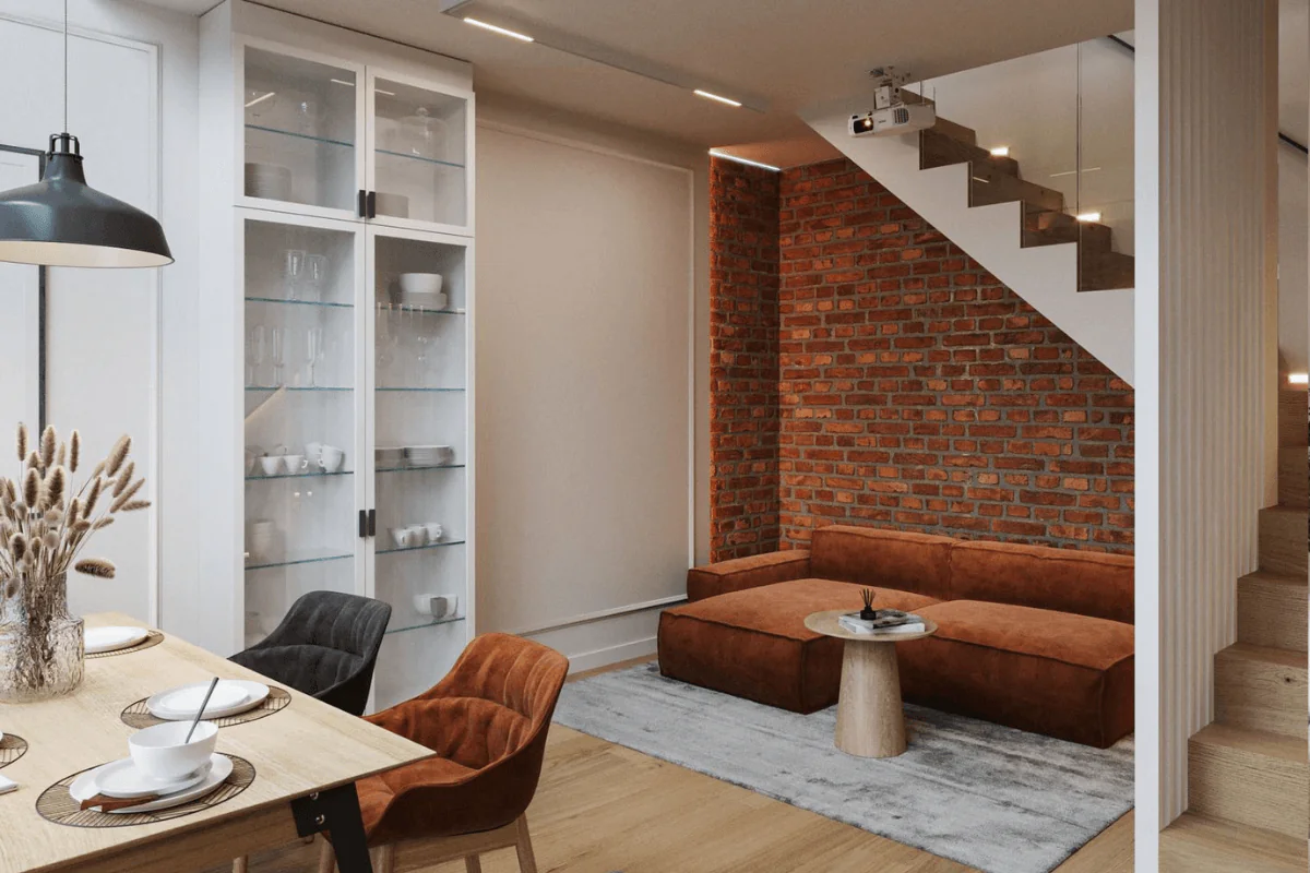 Wnętrze z ceglaną ścianą, brązową sofą i industrialnym stylem