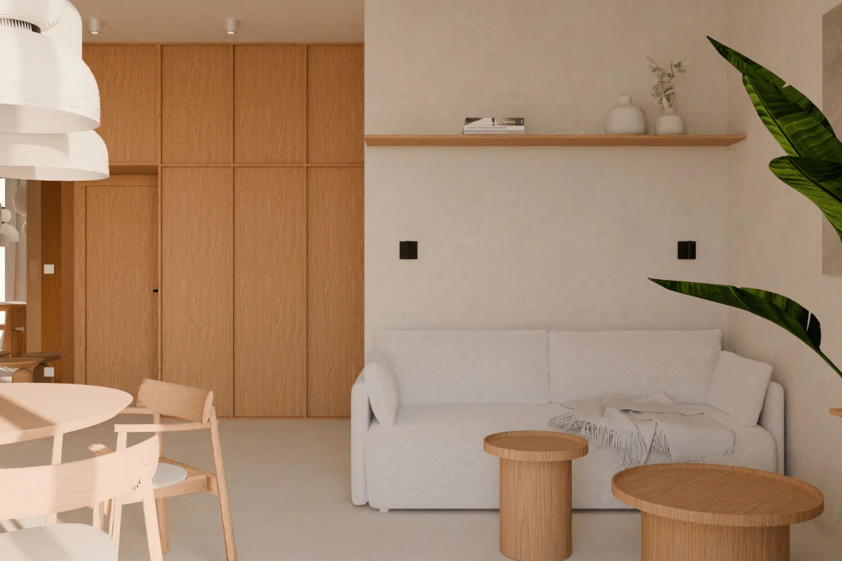 Wnętrze w stylu japandi z jasną sofą i drewnianymi akcentami.