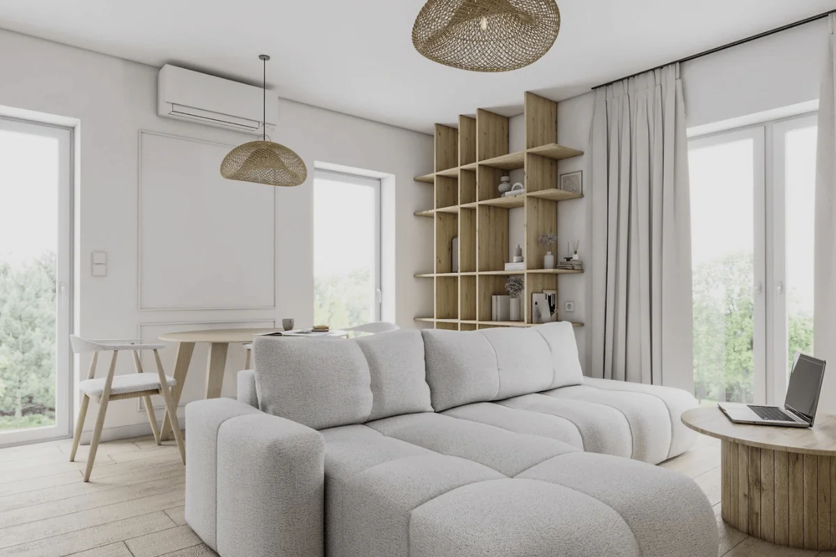 Wnętrze salonu w stylu japandi i skandynawskim z szarym narożnikiem i drewnianymi elementami.