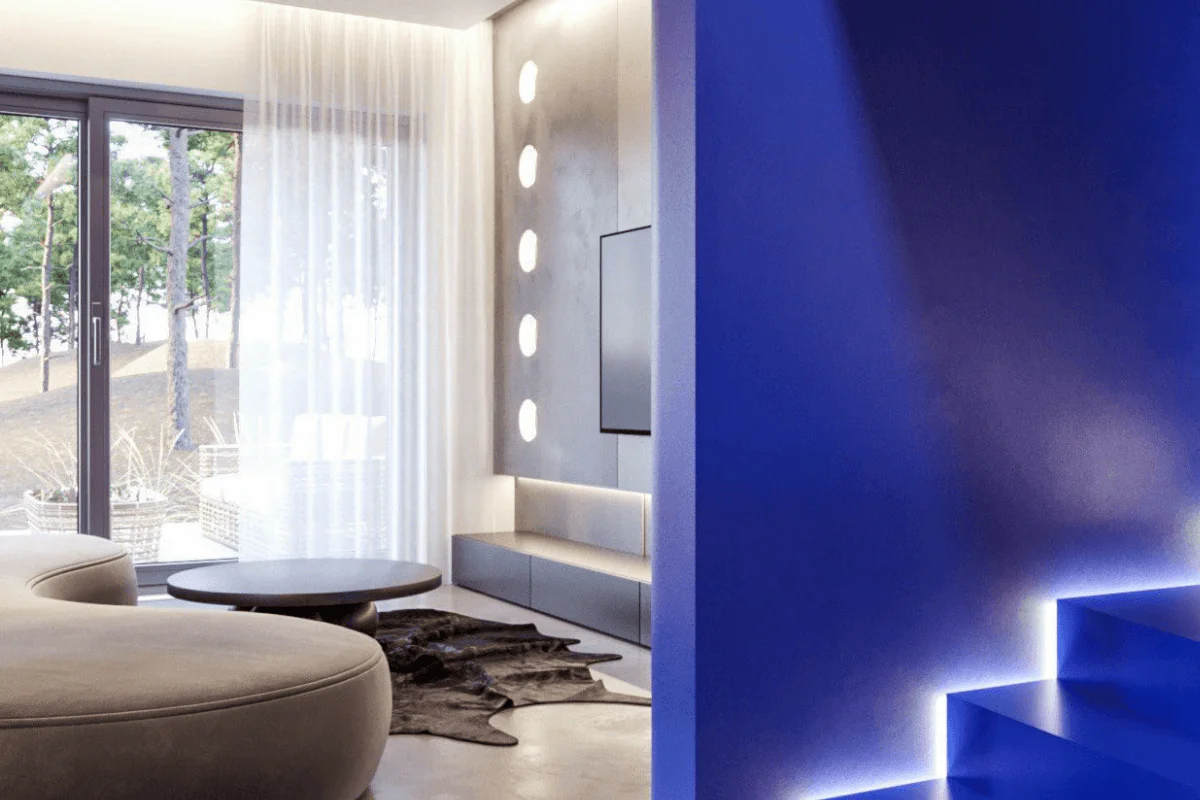 Wnętrze z niebieską ścianą, nowoczesnymi meblami i dużymi oknami w stylu minimalistycznym i industrialnym.
