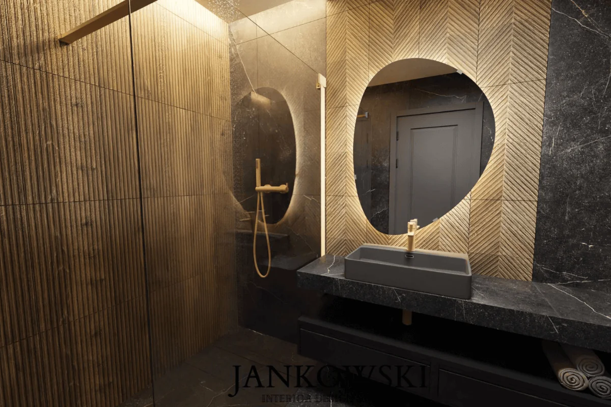 Wnętrze łazienki z czarnym blatem, drewnianymi ścianami i okrągłym lustrem