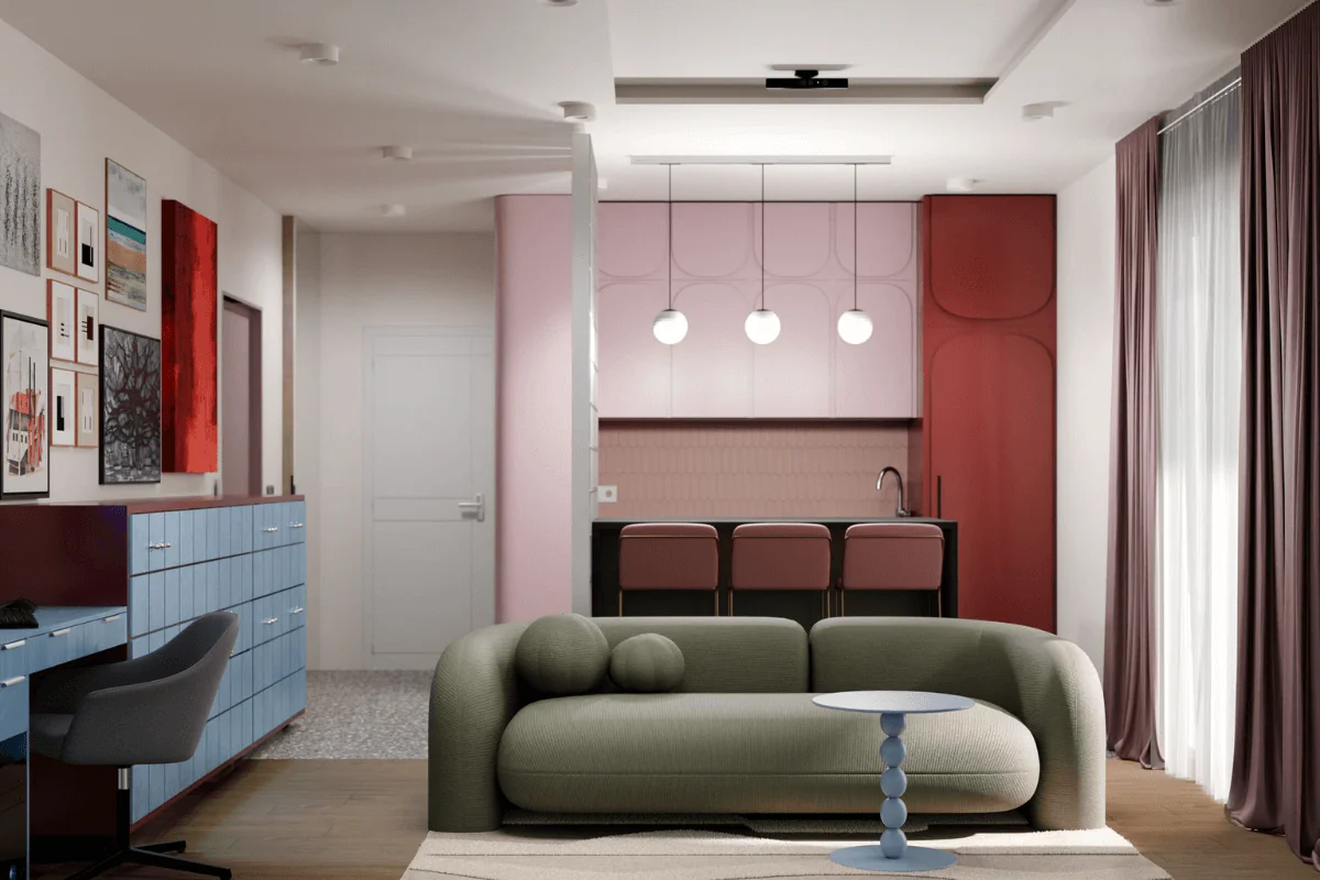 Wnętrze eklektyczne z zieloną sofą, różową kuchnią i dekoracjami na ścianie.