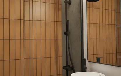 Nowoczesna łazienka z brązowymi płytkami, białą umywalką i minimalistycznym oświetleniem.