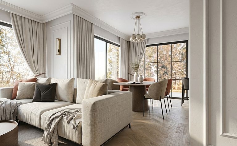 Wnętrze salonu z jasnym narożnikiem, okrągłym stołem i dużymi oknami, styl quiet luxury