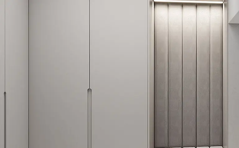 Minimalistyczna garderoba z szarymi szafkami i obszernym siedziskiem.