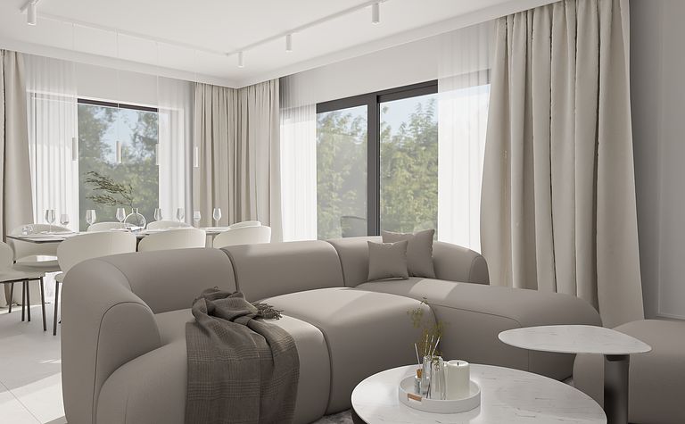 Wnętrze minimalistycznego salonu z szarym narożnikiem i białymi zasłonami.