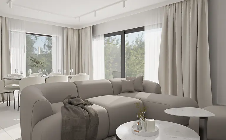 Wnętrze minimalistycznego salonu z szarym narożnikiem i białymi zasłonami.