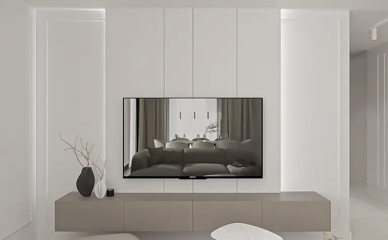 Wnętrze salonu minimalistycznego z jasnymi meblami, nowoczesnym telewizorem i dekoracjami.