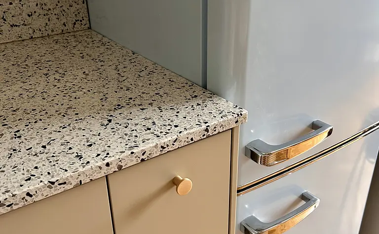 Kuchnia w stylu eklektycznym z błękitną lodówką i jasnymi szafkami, vintage wykończenie.