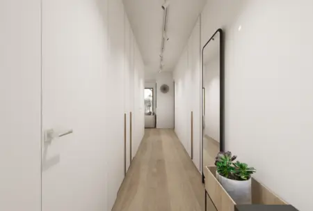 Przedpokój w stylu japandi i minimalistycznym z białymi ścianami i drewnianą podłogą.