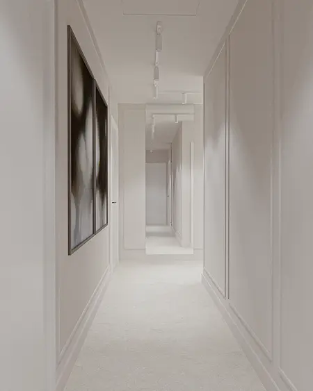 Przedpokój w stylu minimalistycznym z białymi ścianami i oświetleniem sufitowym.
