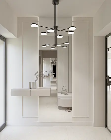 Przedpokój z minimalistycznym wystrojem, białymi ścianami i nowoczesnym oświetleniem.