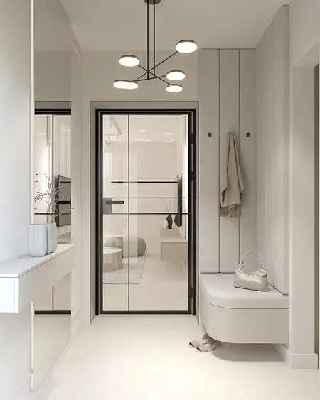 Przedpokój w minimalistycznym stylu z białymi ścianami i nowoczesnymi meblami.