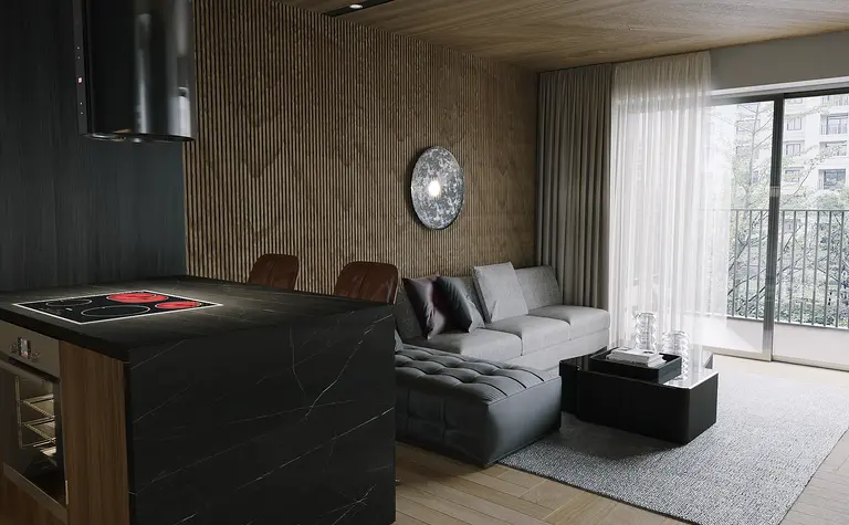 Nowoczesny salon z szarymi meblami, czarną wyspą i drewnianymi akcentami.