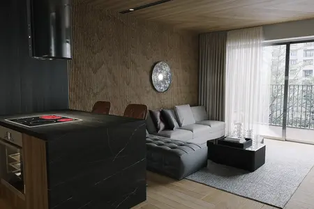 Nowoczesny salon z szarymi meblami, czarną wyspą i drewnianymi akcentami.