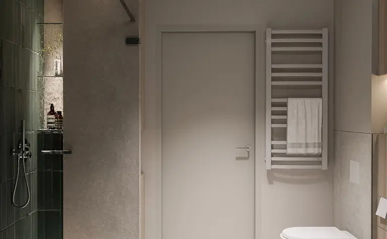 Wnętrze nowoczesnej łazienki z zieloną płytką, minimalistycznymi detalami i soft minimalizmem.