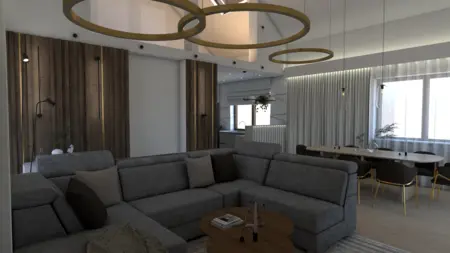 Wnętrze nowoczesnego salonu z szarym narożnikiem i drewnianymi detalami.