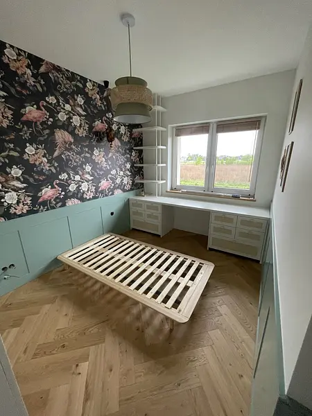 Pokój z kwiatową tapetą, drewnianym łóżkiem, styl art deco, rustykalny i eklektyczny.