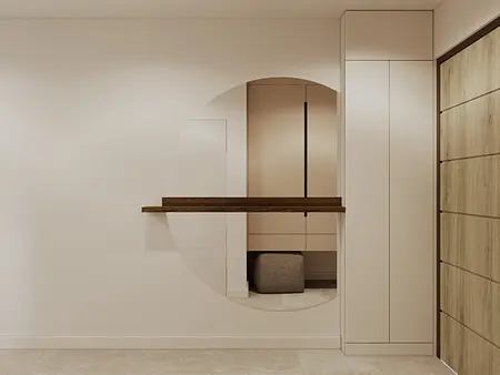 Minimalistyczny przedpokój z beżowymi meblami i nowoczesnymi detalami.