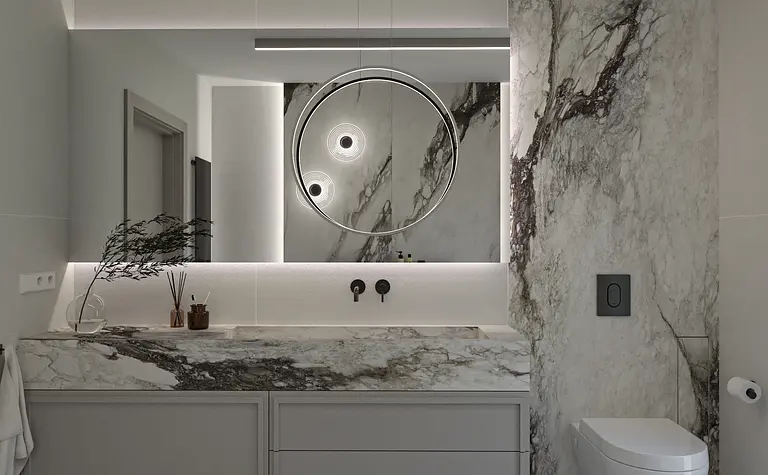 Nowoczesna łazienka z marmurową umywalką, minimalistycznym oświetleniem i współczesnymi akcentami.