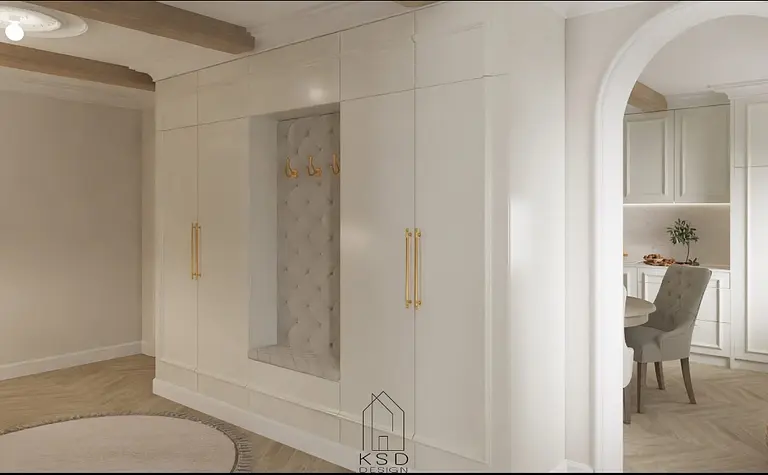 Garderoba w stylu tradycyjnym z białymi meblami i złotymi detalami.