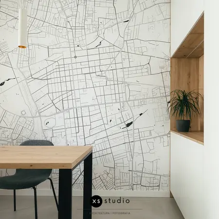 Wnętrze jadalnii w stylu minimalistycznym i skandynawskim z mapą i rośliną