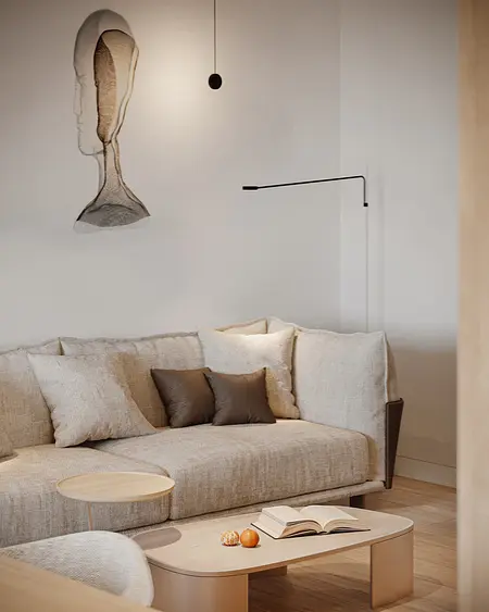 Wnętrze minimalistycznego salonu z beżową sofą i nowoczesną lampą.