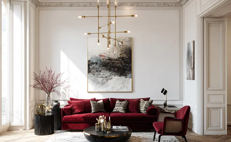 Wnętrze salonu w stylu quiet luxury z czerwonymi meblami i drewnianą podłogą.