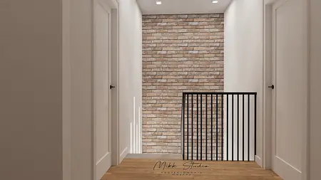 Korytarz z ceglaną ścianą, białymi drzwiami i drewnianą podłogą w stylu współczesnym.