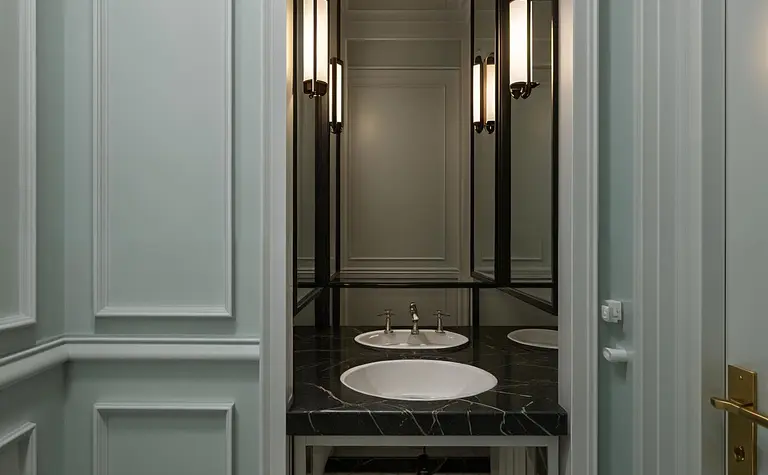 Elegancka łazienka w stylu art deco i vintage z białymi elementami i czarnymi akcentami.