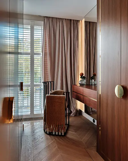 Wnętrze z elementami art deco i japandi, z drewnianą podłogą i zasłonami.