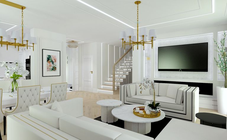 Wnętrze salonu w stylu glamour z białymi meblami i złotymi detalami.