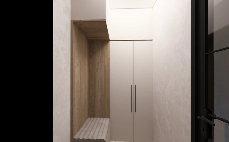 Minimalistyczny przedpokój z białymi meblami i drewnianymi detalami.