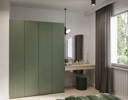 Eklektyczna sypialnia z minimalistycznymi meblami, zieloną szafą i nowoczesnym biurkiem.