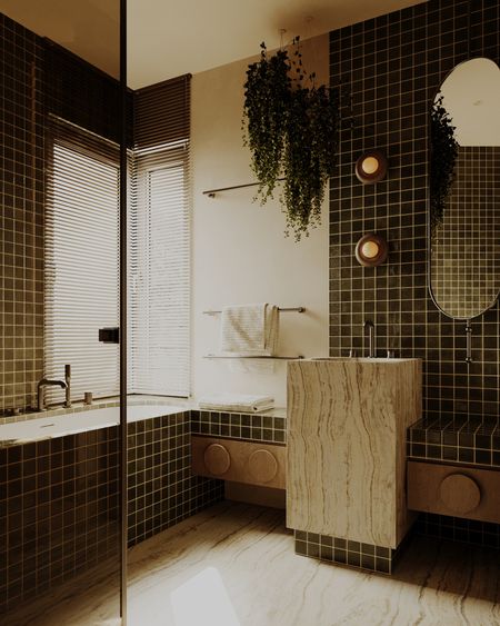 Wnętrze łazienki z ciemnymi płytkami, drewnianym blatem, minimalistycznym i vintage designem.