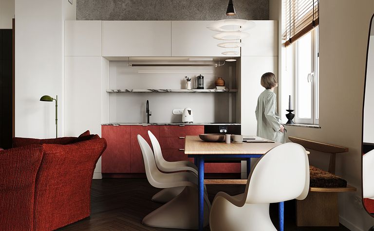 Kuchnia w stylu eklektycznym z czerwonymi akcentami i minimalistycznym wyposażeniem.