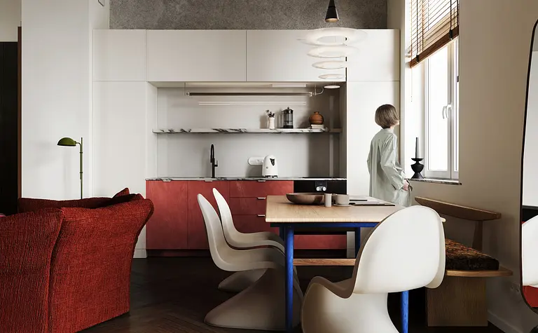 Kuchnia w stylu eklektycznym z czerwonymi akcentami i minimalistycznym wyposażeniem.