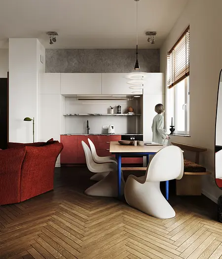 Kuchnia w stylu eklektycznym z czerwonymi akcentami i minimalistycznym wyposażeniem.