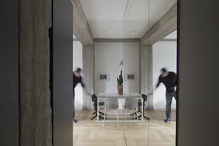 Wnętrze jadalni w stylu eklektycznym i minimalistycznym z białym stołem i czarnymi krzesłami.
