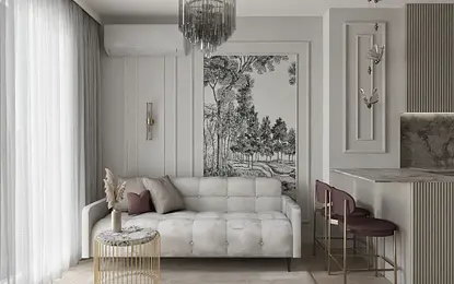 Wnętrze salonu w stylu glamour z białą sofą i szarymi dodatkami.