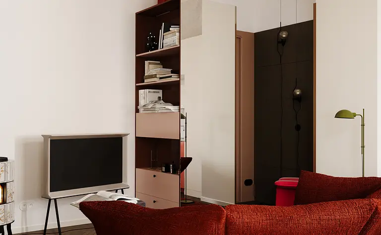 Eklektyczne wnętrze z czerwonym fotelem i telewizorem w minimalistycznym stylu.