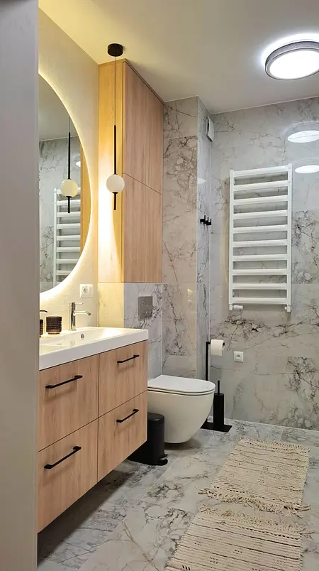 Nowoczesna łazienka z drewnianymi meblami i marmurowymi ścianami