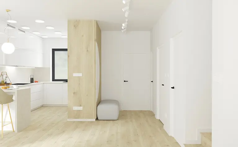 Nowoczesna kuchnia z minimalistycznym wystrojem, białymi meblami i drewnianą podłogą.