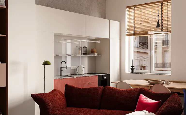 Wnętrze salonu w stylu eklektycznym z czerwonymi akcentami i białą kuchnią