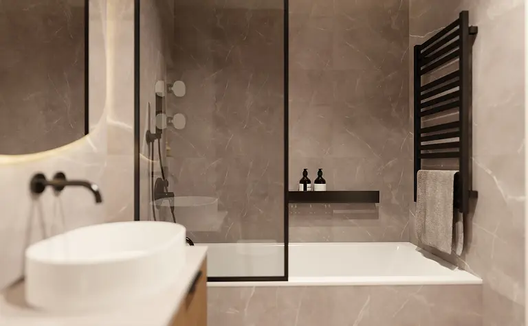 Nowoczesna łazienka z wanną, umywalką i akcentami glamour oraz minimalistycznym designem.