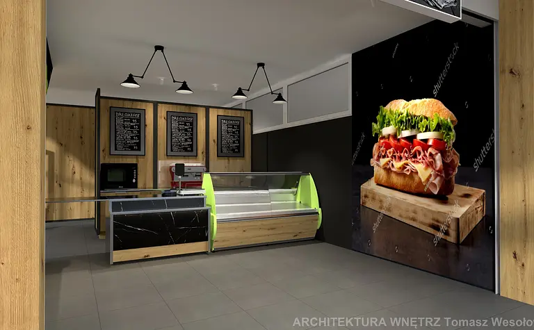 Wnętrze lokalu gastronomicznego z drewnianymi elementami i zielonymi akcentami.