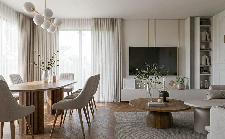 Wnętrze jadalni z okrągłym stołem, szarymi krzesłami i nowoczesnym oświetleniem.