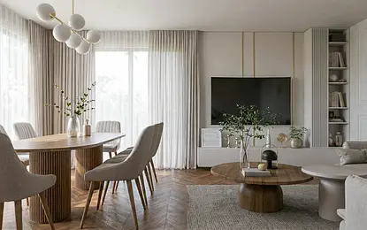 Wnętrze jadalni z okrągłym stołem, szarymi krzesłami i nowoczesnym oświetleniem.